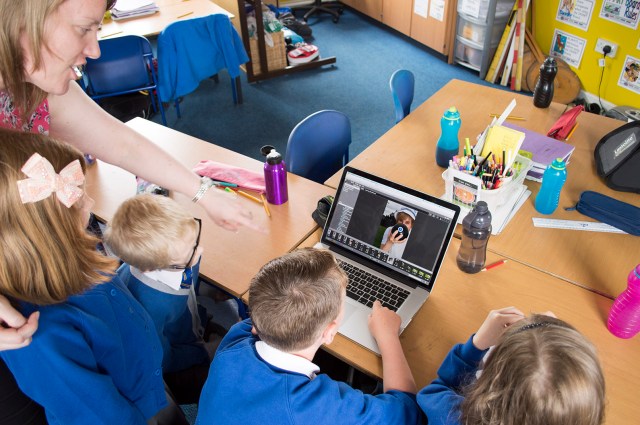 The Webbers working with their teacher Miss Baird to choose their photograph...